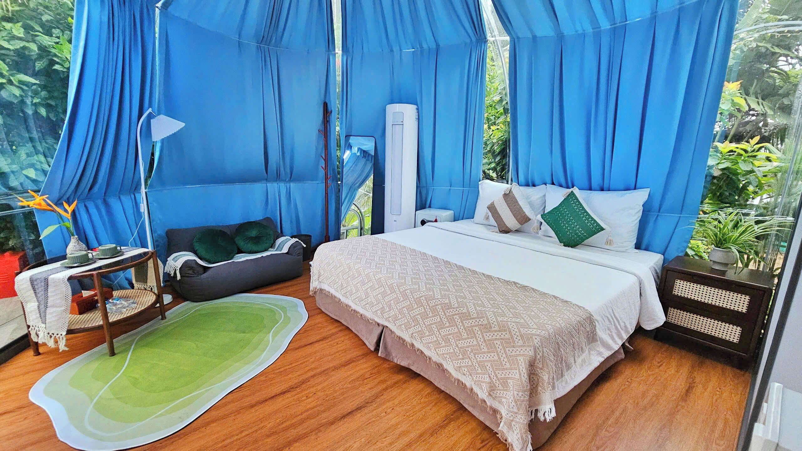 A bedroom with a bed, bedside table, and a chair.