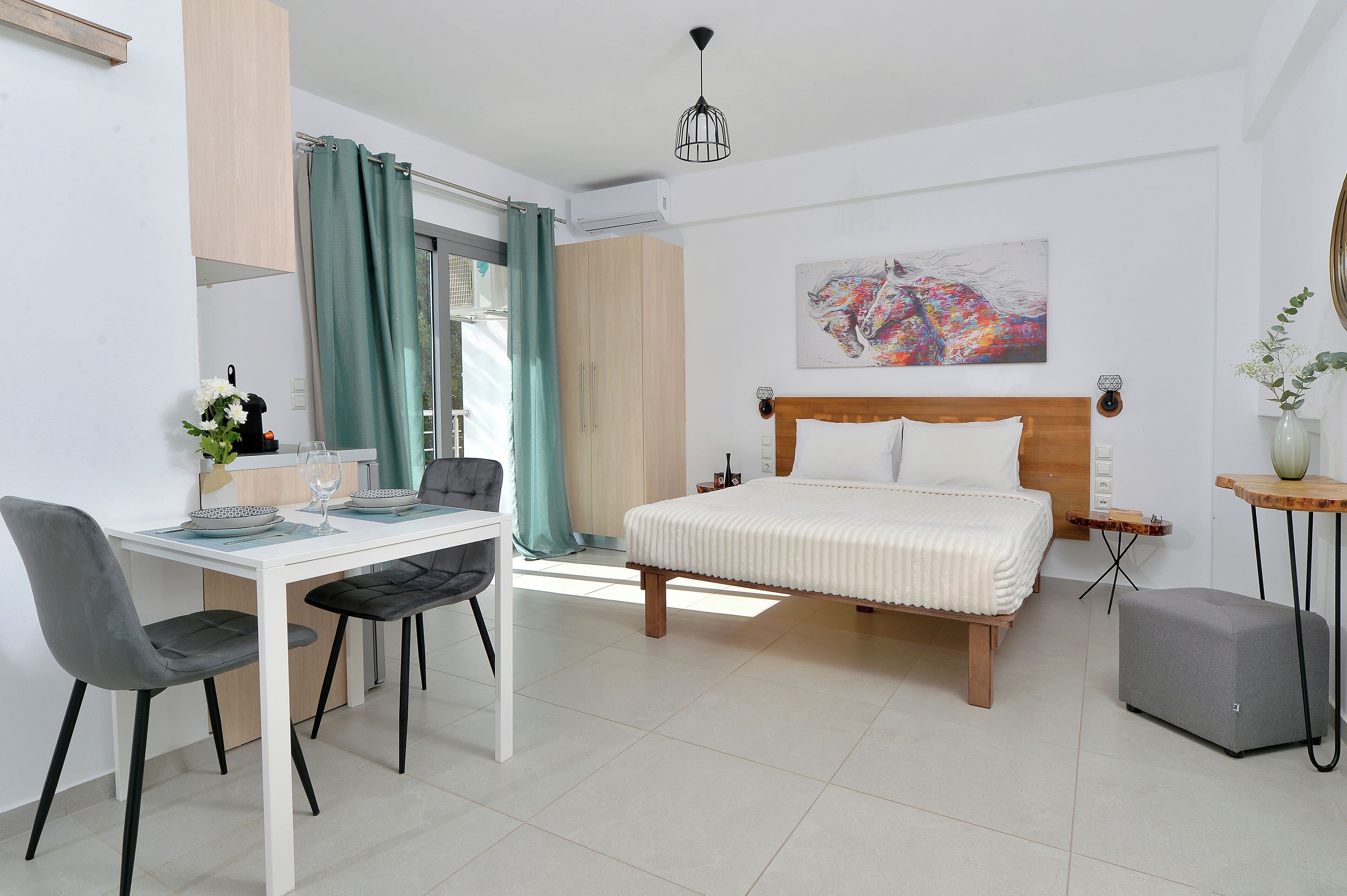 A bedroom with a bed, a desk, and a chair.