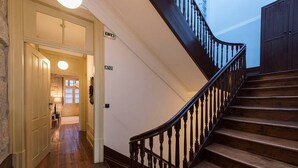 A wooden staircase with a handrail leading to a landing. - Mercado Apartments #3T by DA'HOME (Porto)