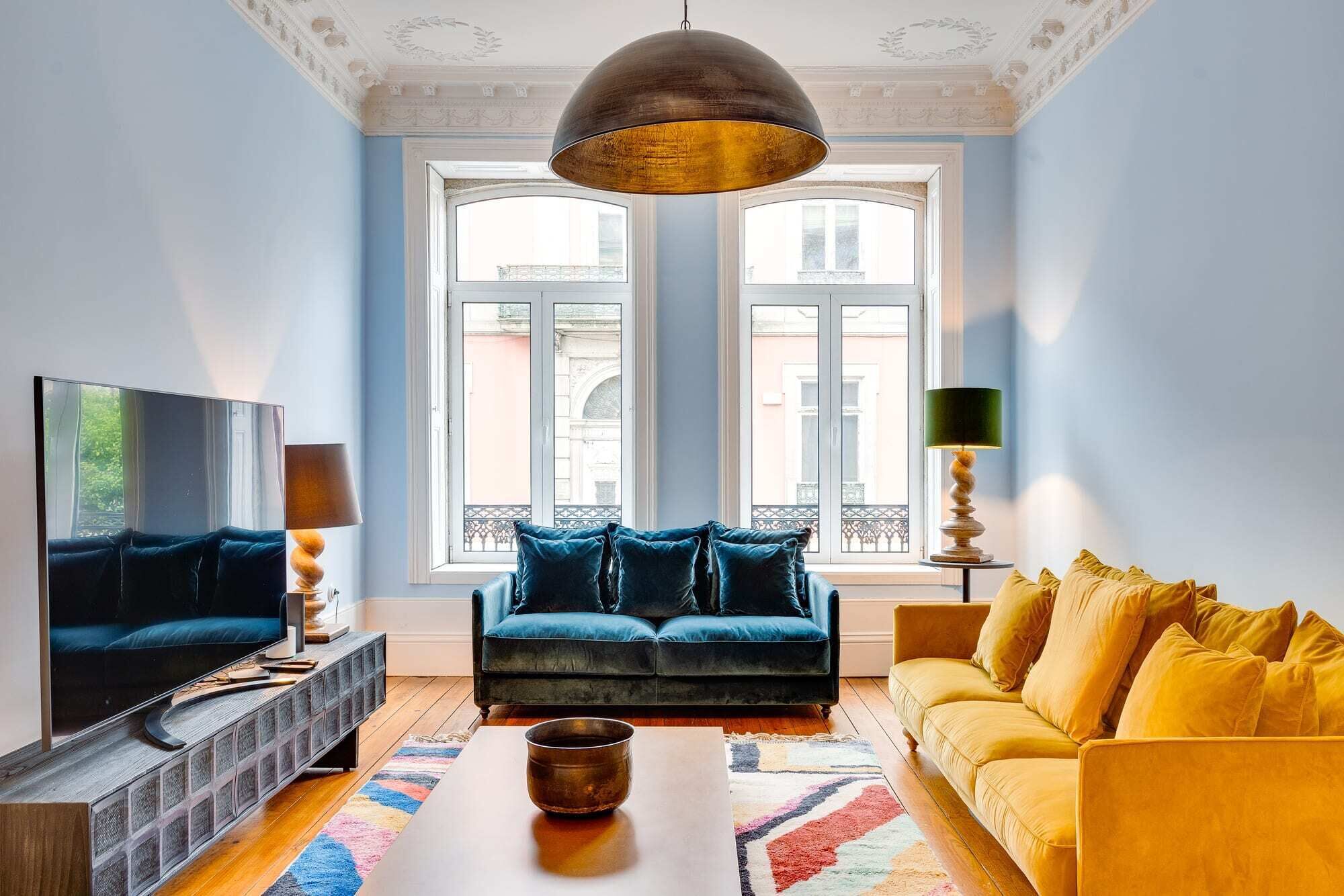 A living room with a TV, sofa, and coffee table.