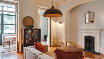 A spacious living room with a fireplace, a large window, and a cozy seating area.