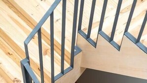 A spiral staircase with a wooden interior and metal railings. - Alma da Casa by DA'Home #1D (Porto)
