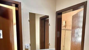 A bathroom with a white sink, a mirror, and a toilet. - Hostel Mar (São Luís)