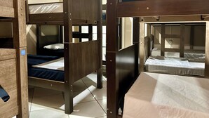 A bunk bed room with wooden frames and a tiled floor. - Hostel Mar (São Luís)