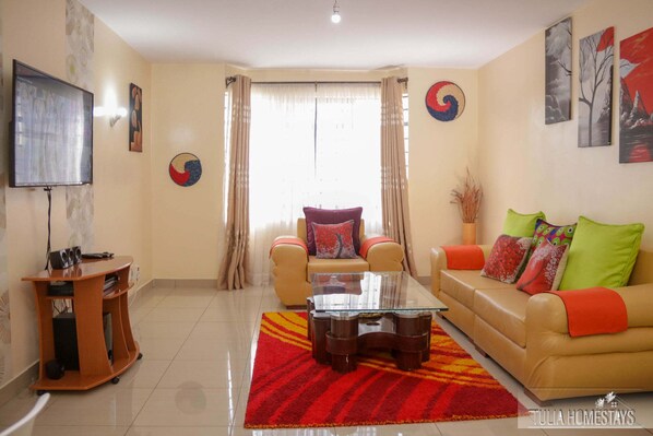 Business Apartment | Living area | 24-inch Smart TV with digital channels