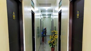 Un couloir avec des portes numérotées 203 et 204, qui donnent accès à des pièces.
