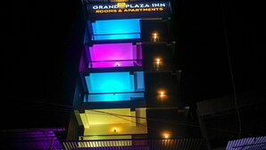 A multi-story building with a sign for "Grand Plaza Inn" and balconies with lights. - Grand Plaza Inn (Tirur)