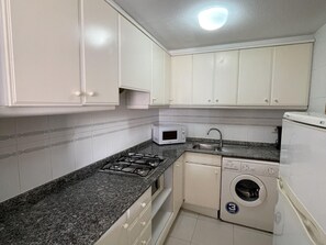 Fridge, microwave, coffee/tea maker, cookware/dishes/utensils