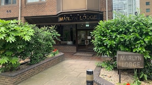 A brick building with a sign reading "MARLYN LODGE".