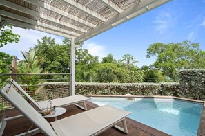 A pool area with lounge chairs, a pergola, and a view of lush greenery. - Villa Baska - Two Bedroom Villa, Sleeps 4 (Les Trois-Îlets)