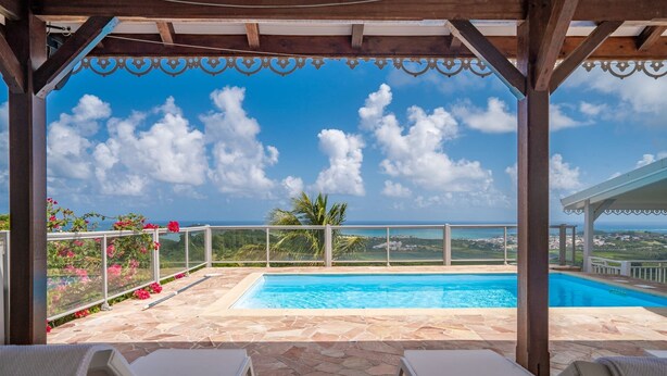 A pool area with a clear view of the ocean and a distant cityscape. - Villa Olga - Two Bedroom Villa, Sleeps 4 (Le Vauclin)