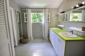 A bathroom with two sinks, a large mirror, and a window with curtains. - Villa Serenity - Four Bedroom Villa, Sleeps 8 (Les Trois-Îlets)