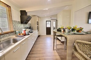 Enjoy meals in this well-lit kitchen with a large island and stainless steel sink.