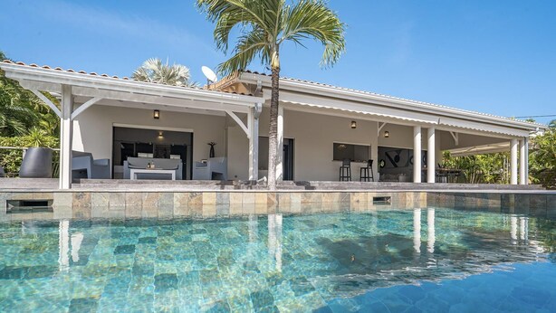 A modern house with a pool, outdoor seating, and a covered patio. - Villa Cactus - Three Bedroom Villa, Sleeps 6 (Le François)