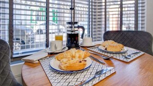 A breakfast table with croissants, a coffee pot, and a cup of coffee. - 15a Furness House (Hartlepool)