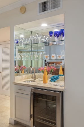 Enjoy cooking in this sleek kitchen with wine storage, stainless steel appliances, and a modern sink.