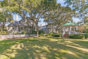 A large house with a gazebo in the front yard.