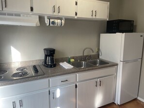 Fridge, microwave, stovetop, coffee/tea maker