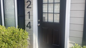 A house with a dark front door, a mailbox, and a number '214' on the wall. - Duplex Style Cabin on Lake Texoma: Cabin 214 (Denison)
