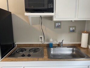 Microwave, stovetop, coffee/tea maker, cookware/dishes/utensils