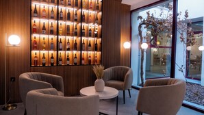 A modern interior with a wine rack, comfortable seating, and a view of the outdoors. - La Hospederia - El Provencio (El Provencio)