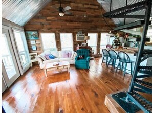 Relax in this inviting space with a comfortable sofa, armchair, and dining area.