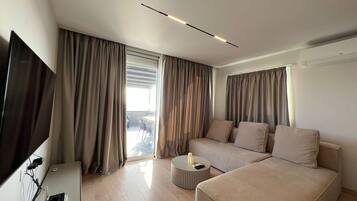 Deluxe Apartment, 1 Bedroom | Living area | 42-inch flat-screen TV with cable channels