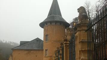 A castle with a turret and a lion statue.