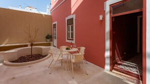 Sit and enjoy the serene atmosphere in this charming outdoor seating area with a table and chairs.