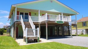 A two-story house with a covered porch and a staircase leading to the upper level. - Vitamin Sea, Almost Oceanfront House in Emerald Isle, NC! (Emerald Isle)