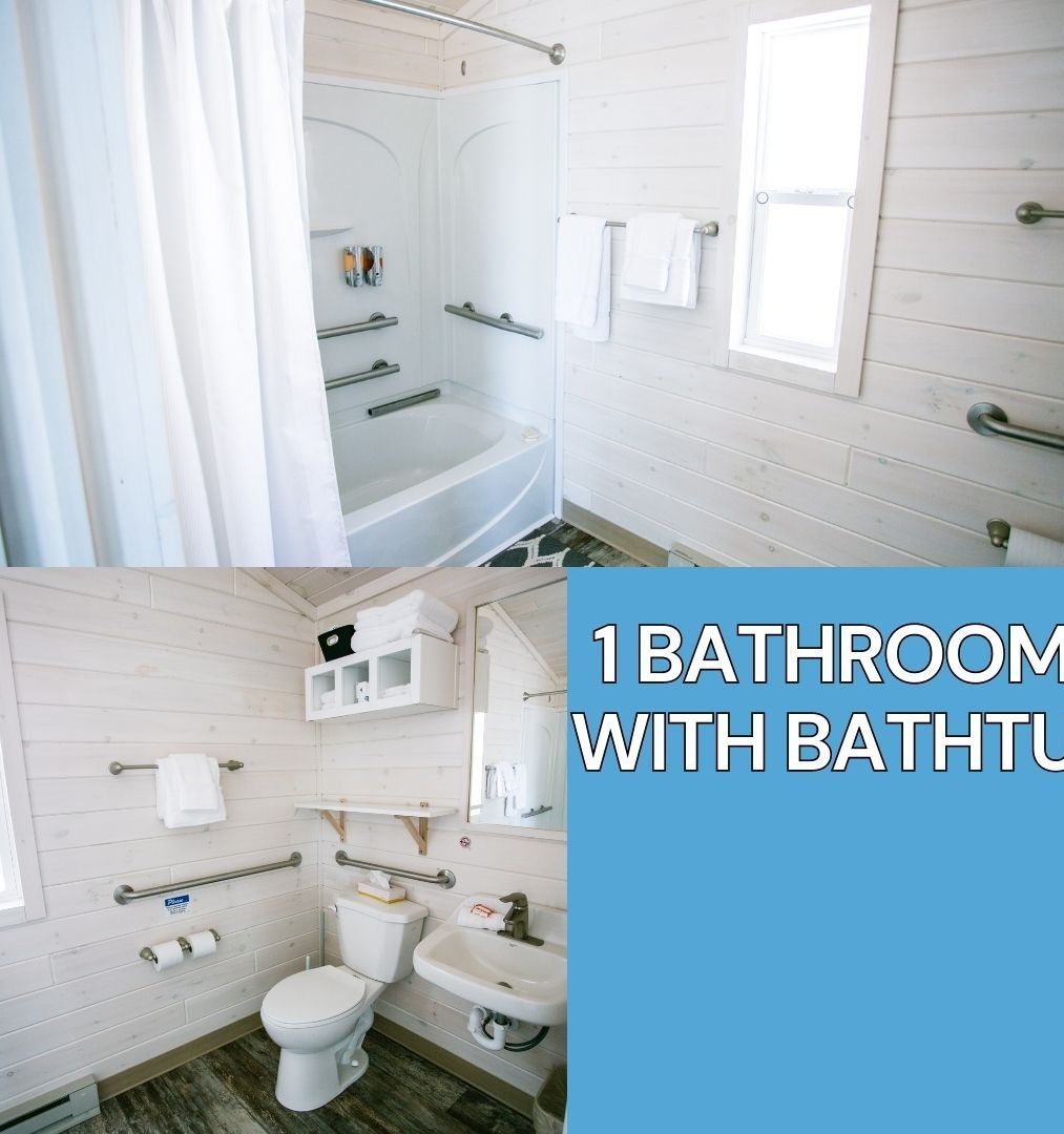 A bathroom with a bathtub, toilet, sink, and handrails.