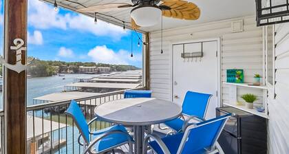 Single-level lake-view condo with dock, outdoor pool, washer/dryer, & central AC