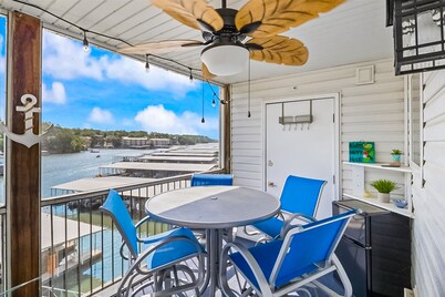 Single-level lake-view condo with dock, outdoor pool, washer/dryer, & central AC