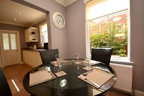Enjoy meals in this dining area with a round table for four and comfortable seating.
