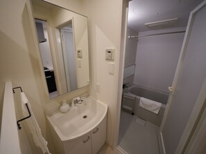 Enjoy a refreshing shower with a view from the glass door.