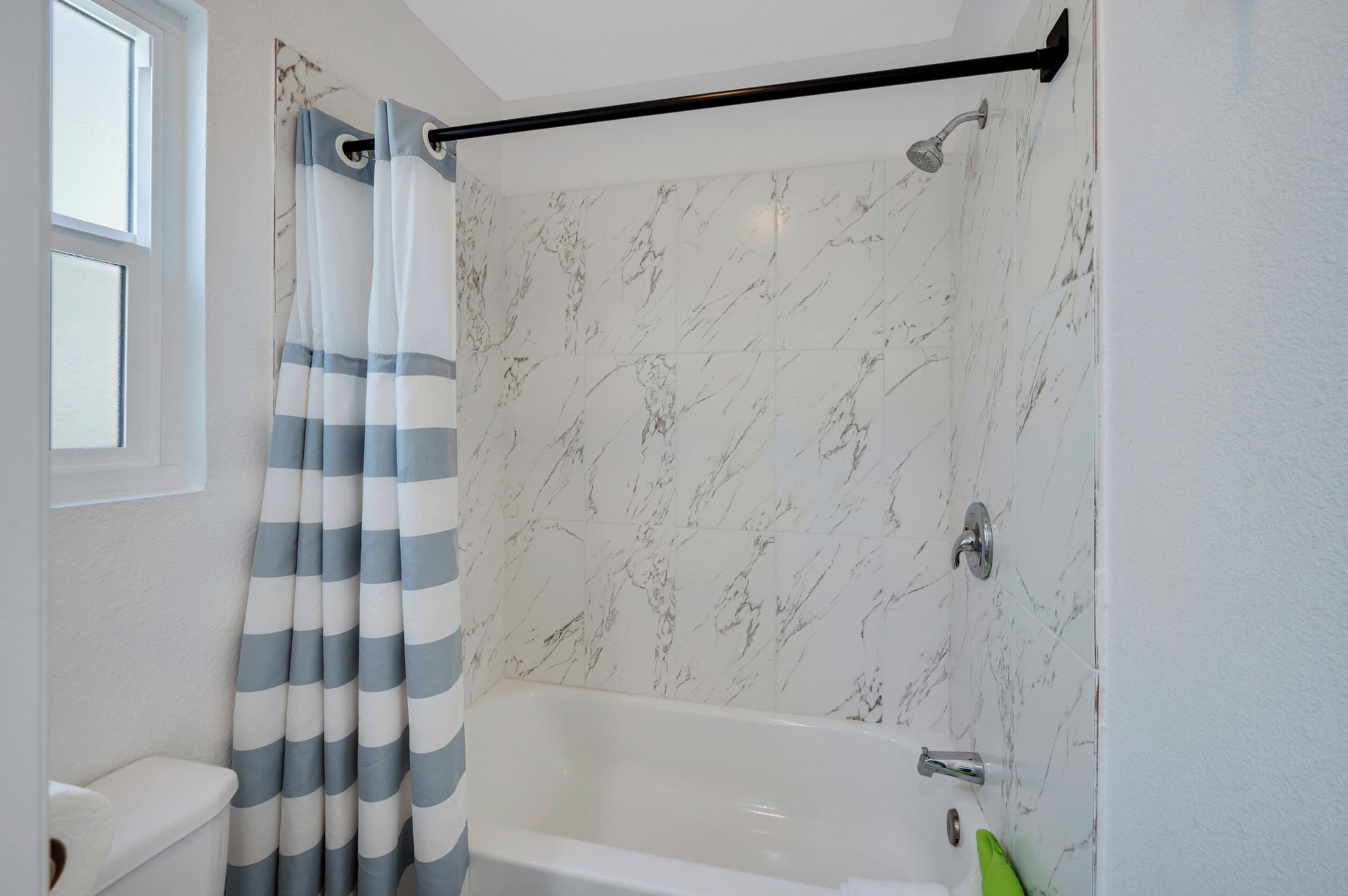 A bathroom with a bathtub, a shower, and a toilet.