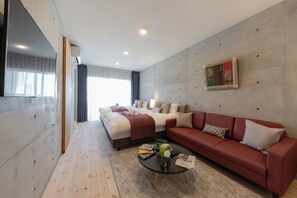 Relax in a stylish space with a large bed, sofa, and flat-screen TV.