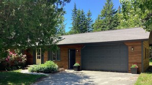 A single-story house with a garage, a front door, and a small porch area.