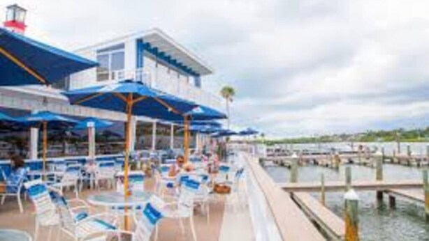 A cruise ship deck with outdoor seating and a pool area. - Heated Pool Close to St Pete Tampa Pet Friendly (Pinellas Park)