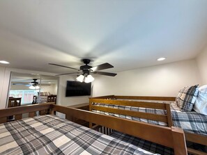 A room with bunk beds, a ceiling fan, a TV, and a window with a view. - 3bd/2ba Remodeled Luxury Home + Steam Shower! (Concord)