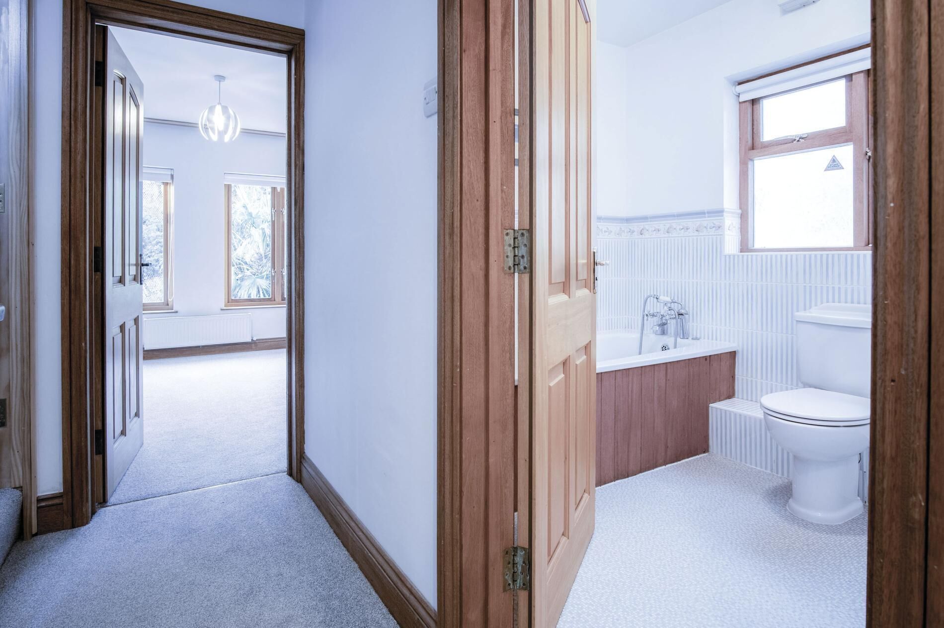 A bathroom with a bathtub, toilet, and sink.