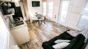 A compact living space with a kitchen, dining area, and a cozy seating area.