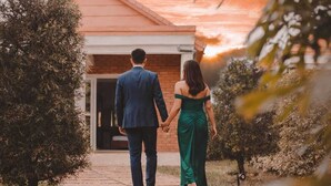 A couple walking on a pathway towards a building with a brick facade. - Mahafaly Hotel & Resort (Antsirabe)