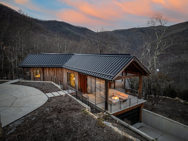 Enjoy serene mountain views from the spacious deck with a fire pit.