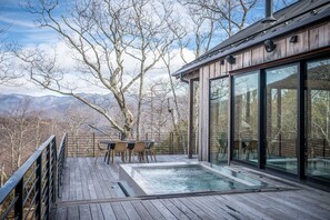 Relax on the elevated deck with a hot tub and enjoy the surrounding landscape.