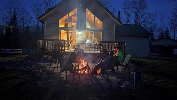 A modern house with a large deck and a fire pit in the center. - Adventure in the Blue Hills! Great for Hiking, ATV's 
 snowmobiling & hunting (Weyerhaeuser)
