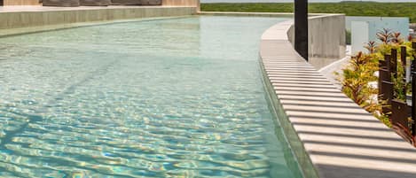 7 outdoor pools, open 9:30 AM to 9:00 PM, pool umbrellas, pool loungers