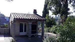 A small stone building with a tiled roof, a door, and a small porch. - Holiday Home 'Frejus' with Shared Pool, Shared Terrace and Air Conditioning (Frejus)