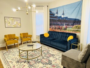 Relax in this inviting living room with a comfortable sofa, armchairs, and a stylish coffee table.