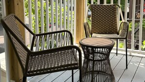 A wooden deck with two wicker chairs and a small round table. - 3BR2Bth TD Garden/BOS/MIT/Harvard/2 Parking Spaces (Somerville)